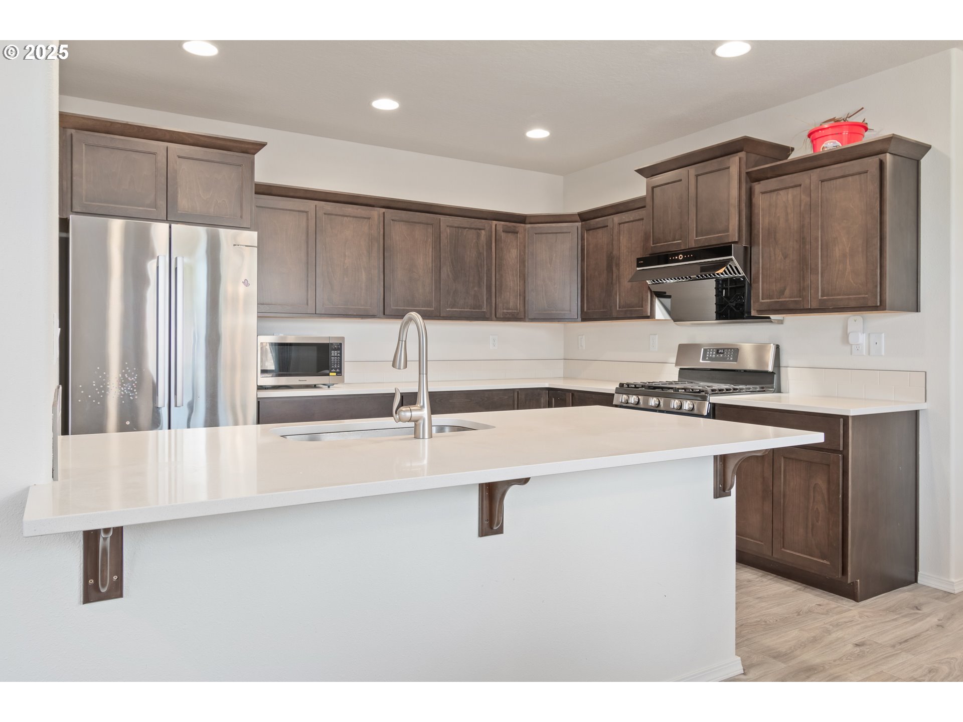 5292 Squirrel Street Springfield, OR 97478 - Photo 8 of 34 a kitchen with kitchen island a sink stainless steel appliances and cabinets