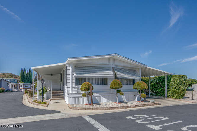 6480 Katherine Road, Unit 121 Simi Valley, CA 93063 - Photo 1 of 34 a front view of a house with garden