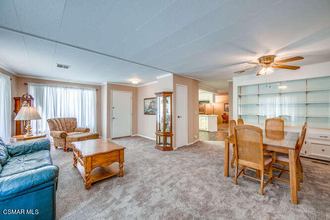 6480 Katherine Road, Unit 121 Simi Valley, CA 93063 - Photo 11 of 34 a living room with furniture and a chandelier
