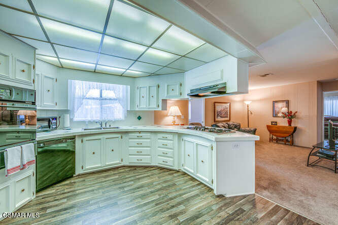 6480 Katherine Road, Unit 121 Simi Valley, CA 93063 - Photo 13 of 34 a kitchen with cabinets a sink and appliances in it