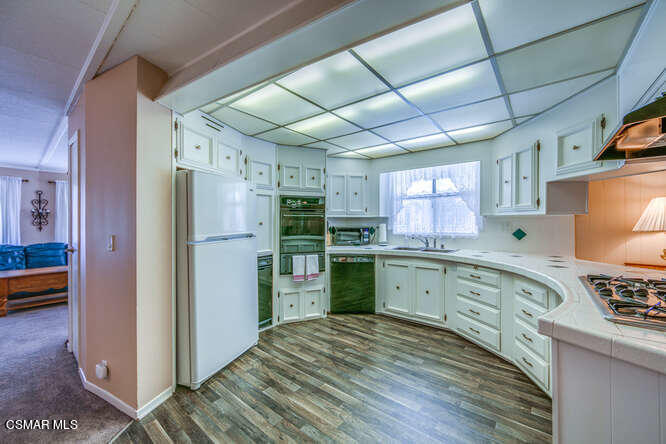 6480 Katherine Road, Unit 121 Simi Valley, CA 93063 - Photo 14 of 34 a kitchen with a refrigerator and a sink