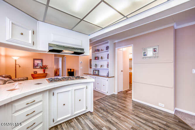 6480 Katherine Road, Unit 121 Simi Valley, CA 93063 - Photo 15 of 34 a kitchen with a sink a refrigerator and cabinets