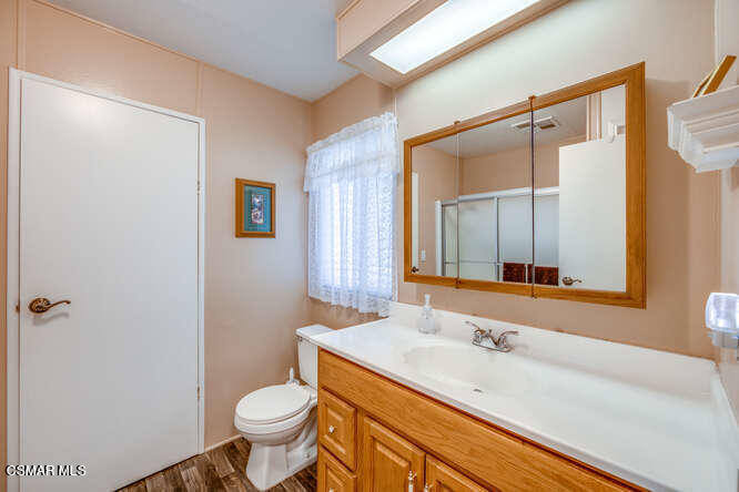 6480 Katherine Road, Unit 121 Simi Valley, CA 93063 - Photo 17 of 34 a bathroom with a granite countertop sink toilet and shower