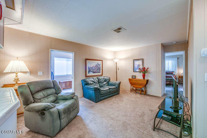 6480 Katherine Road, Unit 121 Simi Valley, CA 93063 - Photo 19 of 34 a living room with furniture and a table
