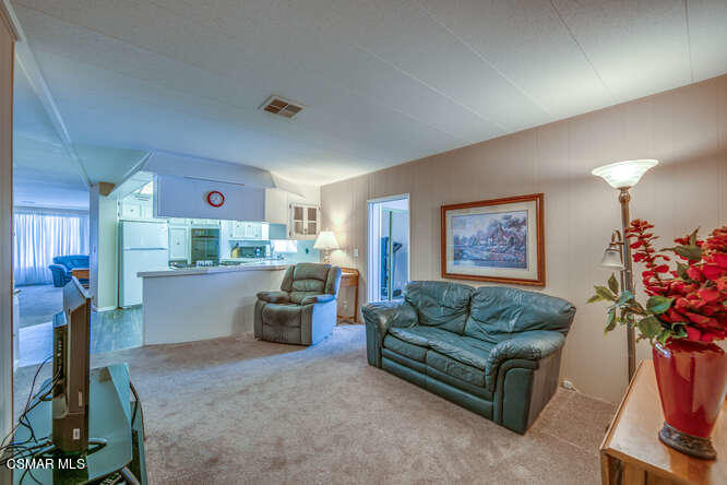 6480 Katherine Road, Unit 121 Simi Valley, CA 93063 - Photo 20 of 34 a living room with furniture and flowers