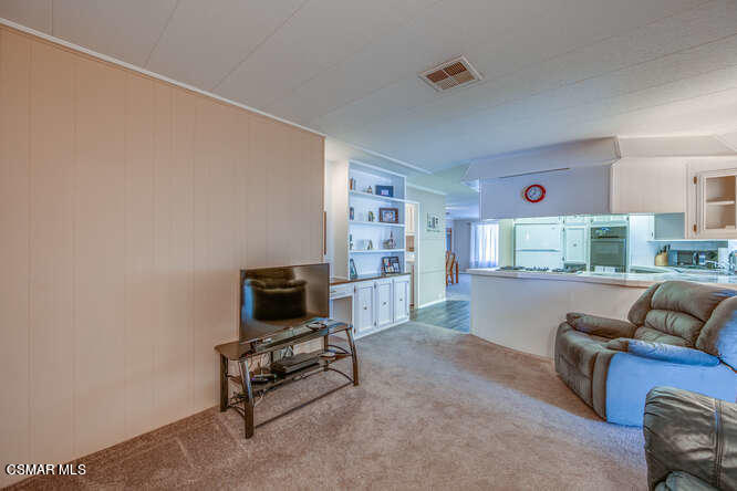 6480 Katherine Road, Unit 121 Simi Valley, CA 93063 - Photo 21 of 34 a living room with furniture and a flat screen tv