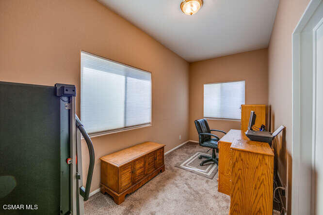 6480 Katherine Road, Unit 121 Simi Valley, CA 93063 - Photo 22 of 34 a room with furniture a rug and a window