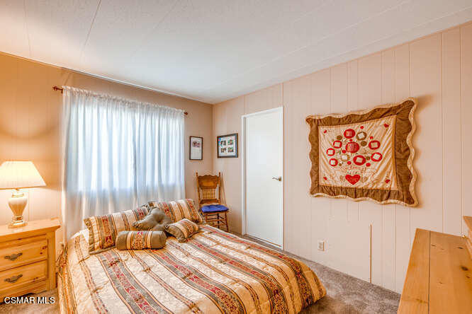 6480 Katherine Road, Unit 121 Simi Valley, CA 93063 - Photo 24 of 34 a bedroom with a bed and a window