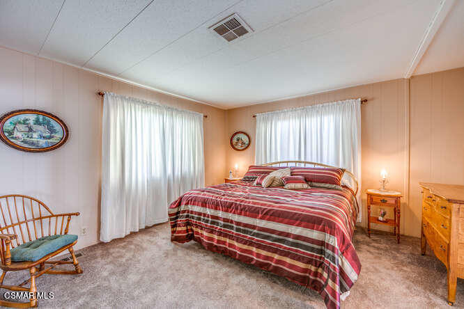 6480 Katherine Road, Unit 121 Simi Valley, CA 93063 - Photo 26 of 34 a bedroom with a bed and a window