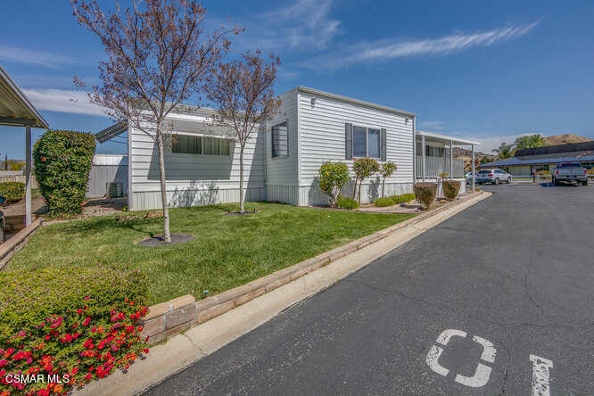6480 Katherine Road, Unit 121 Simi Valley, CA 93063 - Photo 6 of 34 a front view of a house with a yard