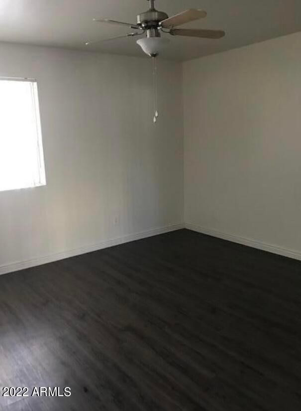 2021 West Hayward Avenue, Unit 5 Phoenix, AZ 85021 - Photo 13 of 15 an empty room with wooden floor fan and windows