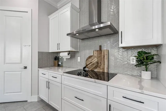 a kitchen with stainless steel appliances kitchen island a table and chairs in it