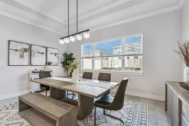 a work room with furniture a rug and a window