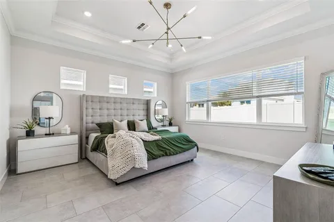 a living room with a bed furniture and next to a window