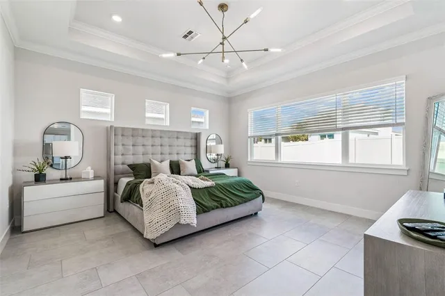 a living room with a bed furniture and next to a window