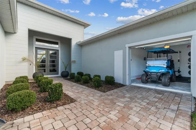 a living room with furniture and chandelier