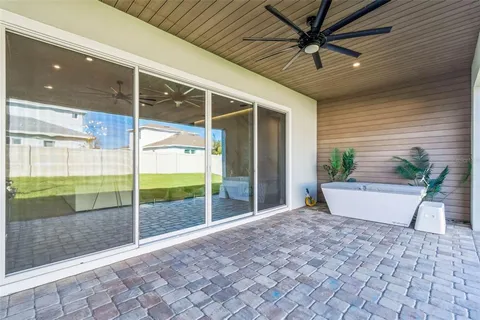 a view of a swimming pool with a yard and sitting space