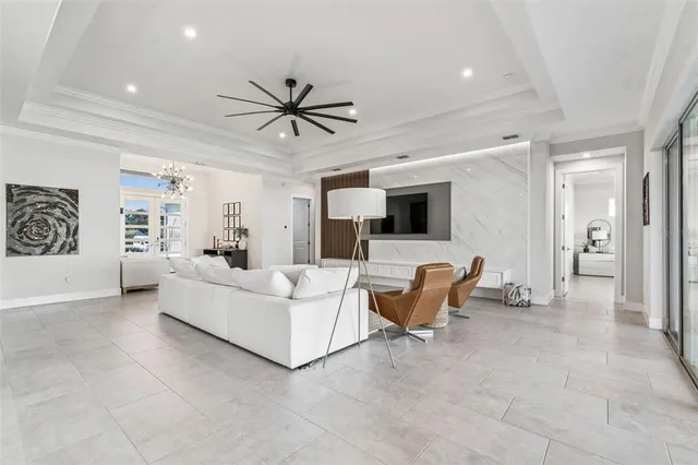 a large kitchen with white cabinets a sink dishwasher a stove a dining table and chairs