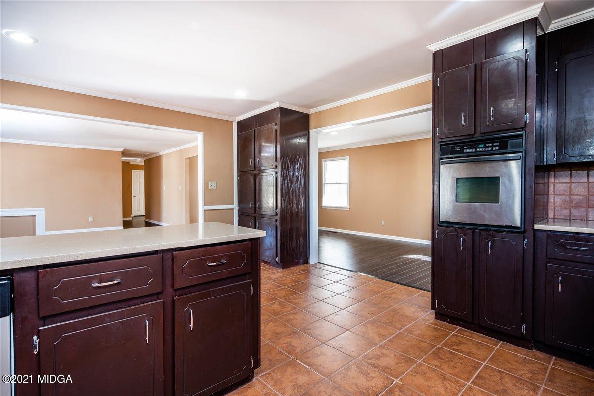 3309 Sandy Circle Macon, GA 31216 - Photo 12 of 35 a kitchen with stainless steel appliances granite countertop a refrigerator and a sink