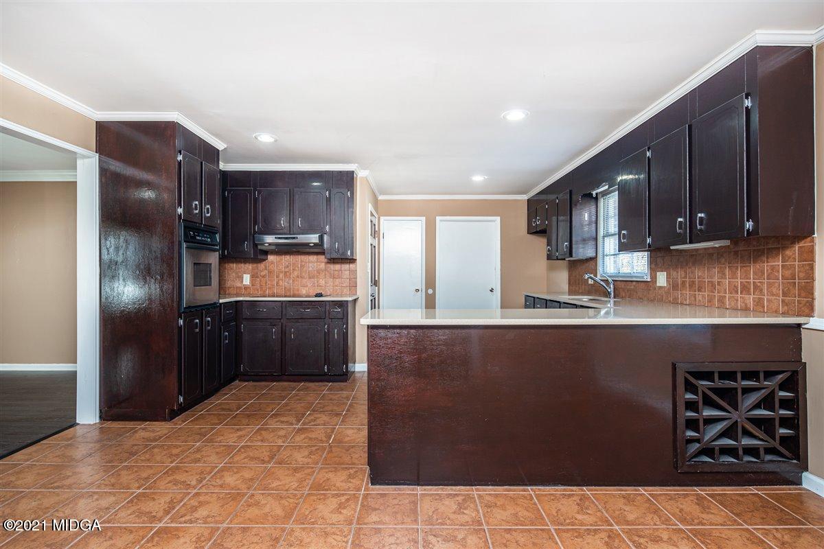 3309 Sandy Circle Macon, GA 31216 - Photo 17 of 35 a kitchen with stainless steel appliances a refrigerator sink stove microwave and cabinets