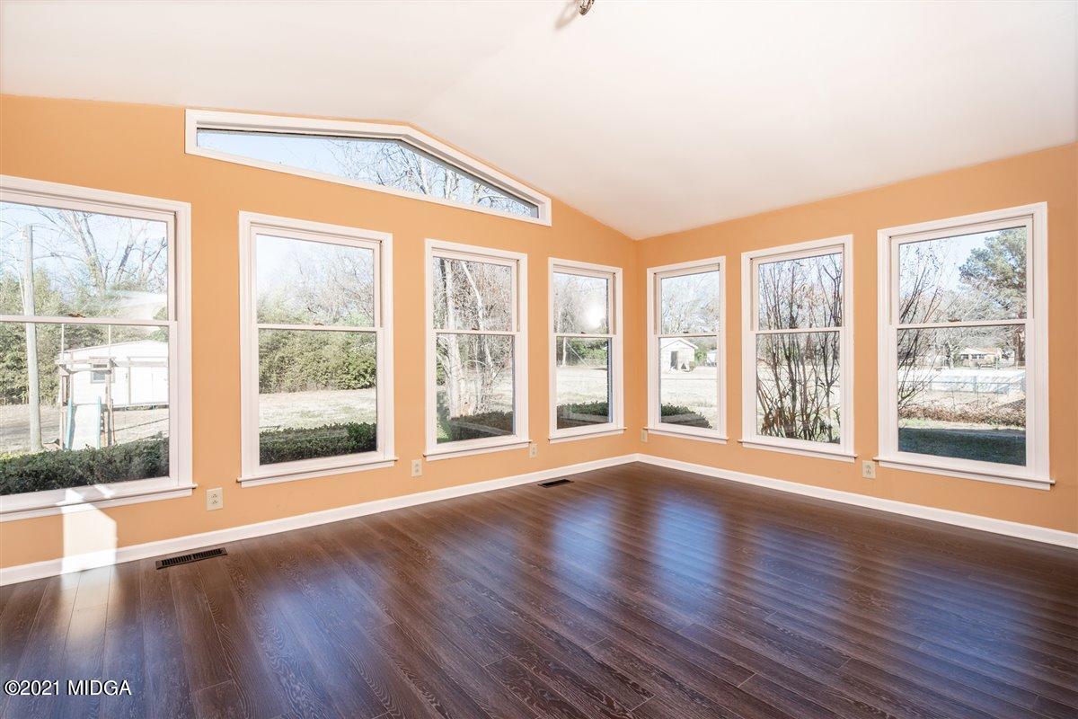 3309 Sandy Circle Macon, GA 31216 - Photo 18 of 35 a view of an empty room with wooden floor and a large window