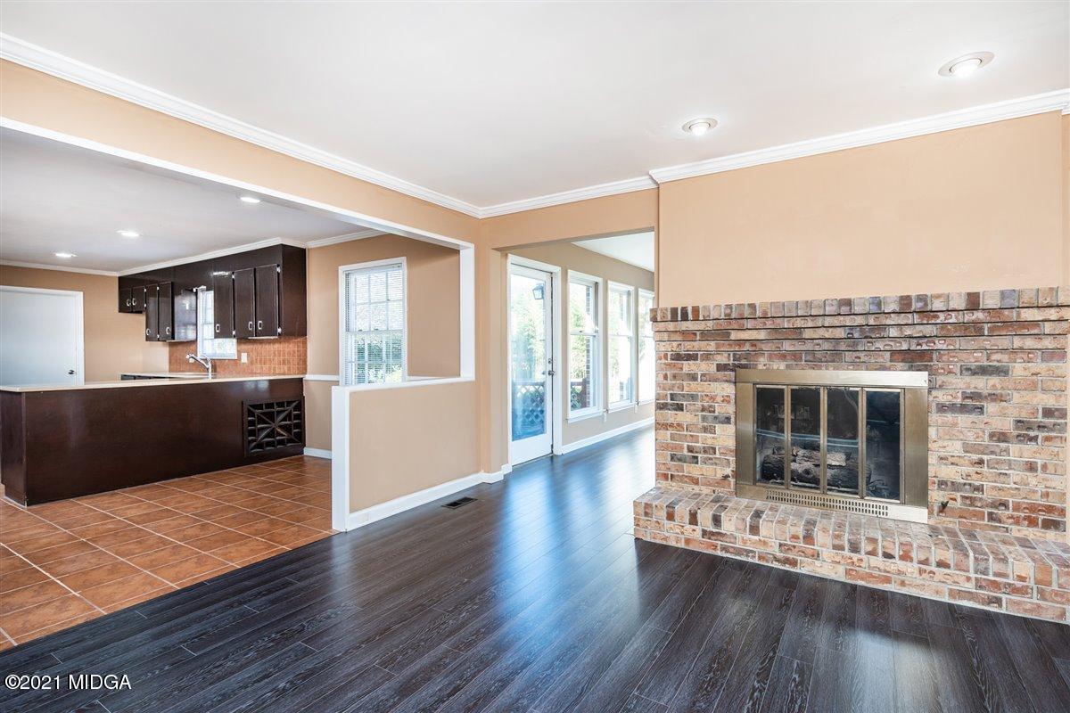 3309 Sandy Circle Macon, GA 31216 - Photo 21 of 35 a living room with furniture wooden floor and a fireplace