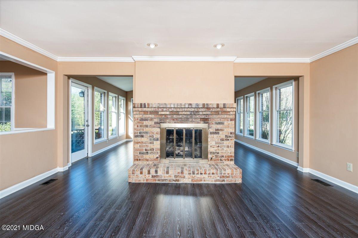 3309 Sandy Circle Macon, GA 31216 - Photo 22 of 35 a view of a living room and wooden floor a fireplace