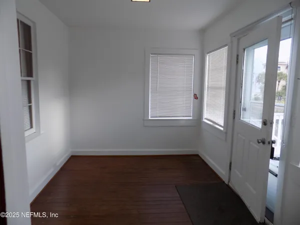 a view of small space with wooden floor and windows