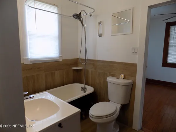 a room with a sink cabinets and a window