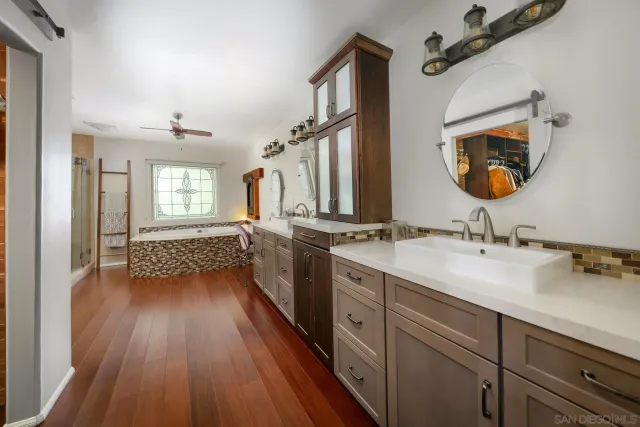 a bed sitting in a bedroom next to a lamp and a lamp