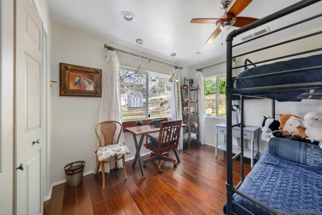 a view of a house with backyard and a tree