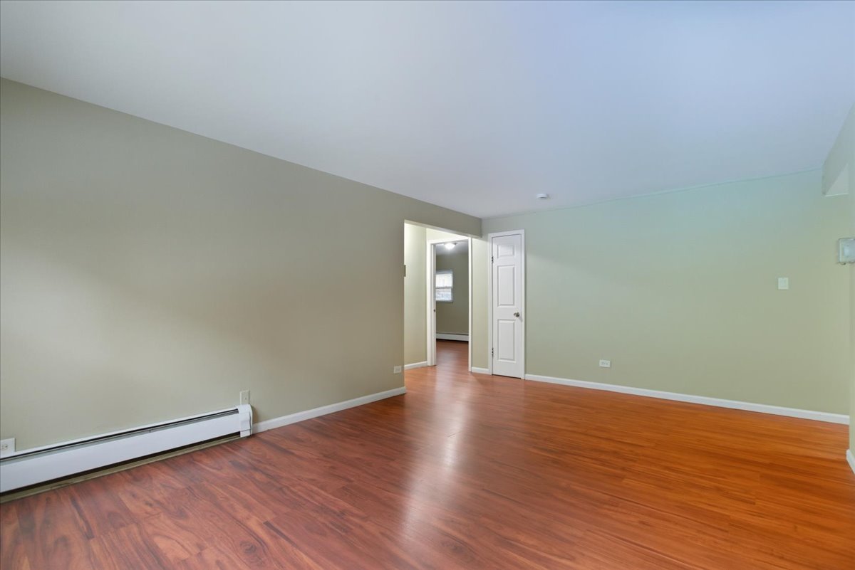 337 Custer Avenue, Unit G Evanston, IL 60202 - Photo 11 of 11 a view of an empty room and wooden floor