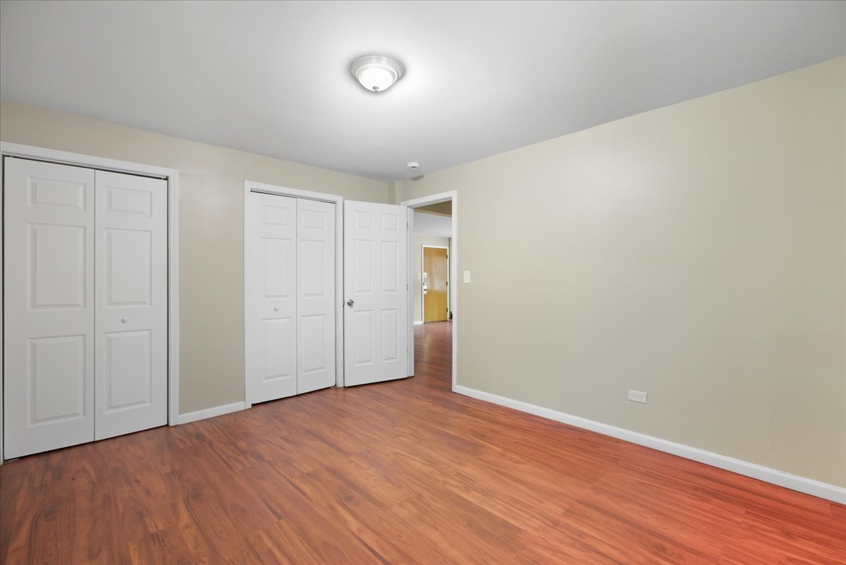 337 Custer Avenue, Unit G Evanston, IL 60202 - Photo 6 of 11 a view of an empty room with wooden floor