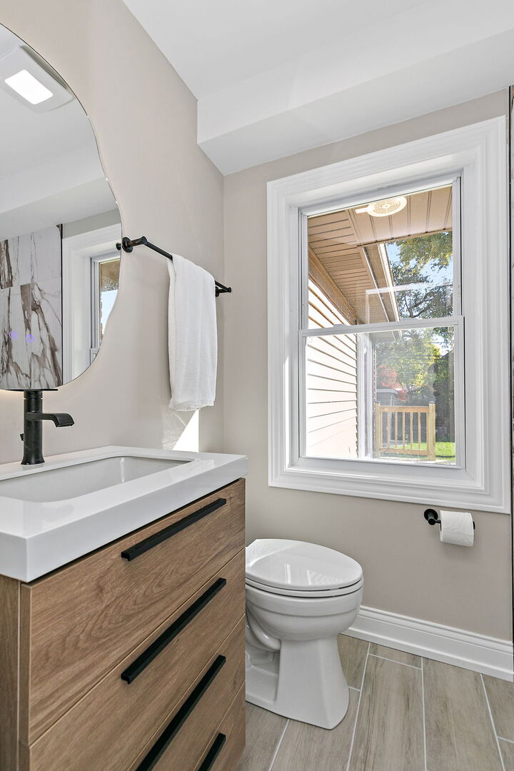 241 North Hamlin Avenue Park Ridge, IL 60068 - Photo 21 of 52 a bathroom with a sink a toilet and a window