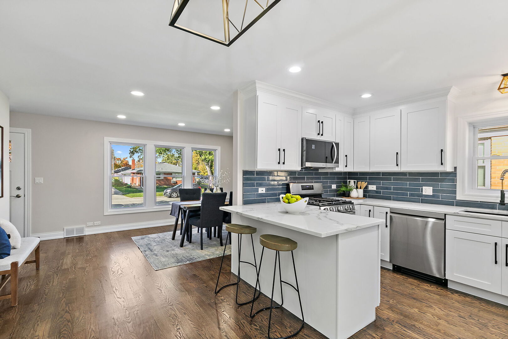 241 North Hamlin Avenue Park Ridge, IL 60068 - Photo 4 of 52 a kitchen with a dining table chairs wooden floor and appliances