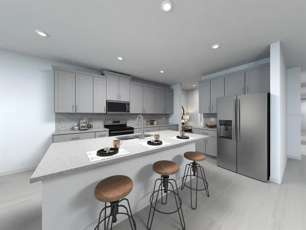 a kitchen with a dining table chairs refrigerator and microwave