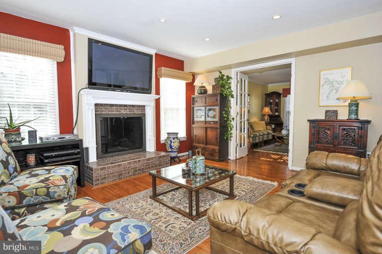 7723 Huntsman Boulevard Springfield, VA 22153 - Photo 12 of 29 Cozy family room with wood-burning fireplace