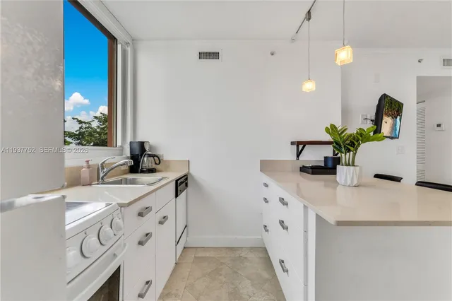 a spacious bathroom with double vanity and a mirror
