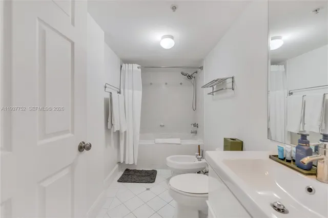 a bathroom with a sink toilet vanity and shower