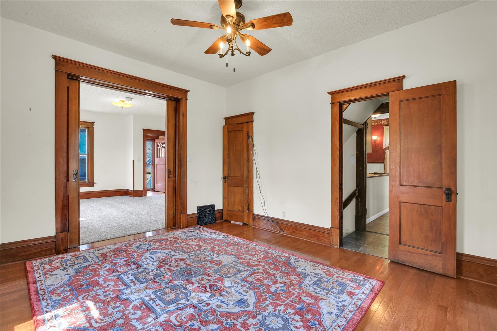 430 Indiana Avenue De Land, IL 61839 - Photo 13 of 48 a view of a hallway with wooden floor and a chandelier