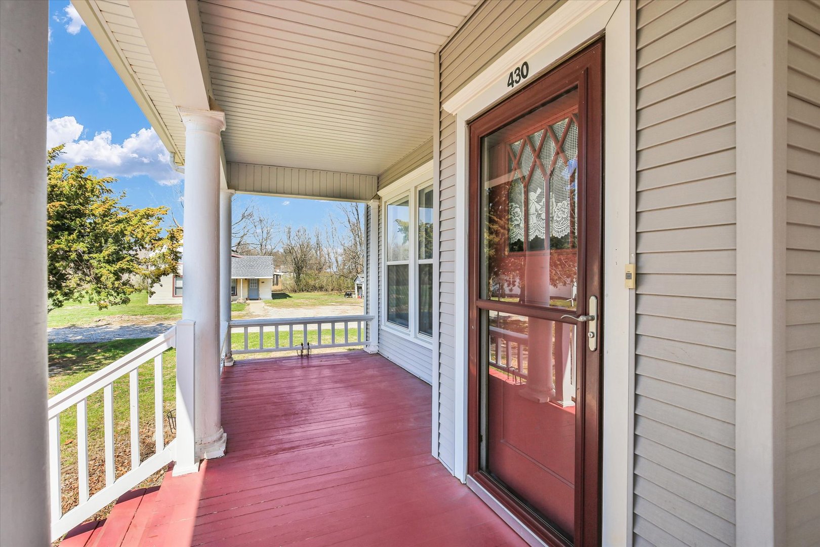 430 Indiana Avenue De Land, IL 61839 - Photo 6 of 48 a view of a porch with a furniture and garden