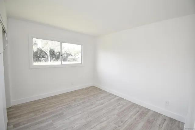 a view of a small space with wooden floor