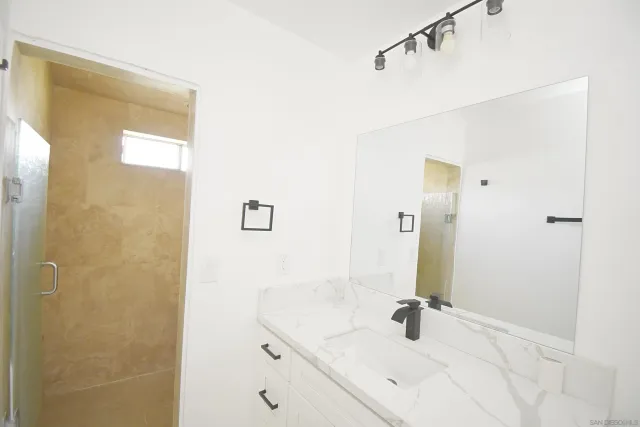 a bathroom with a sink a vanity and a window