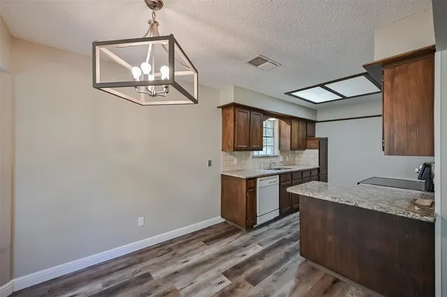 a view of a kitchen with sink microwave and stove
