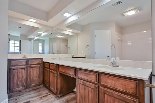 a bathroom with a sink double vanity and a mirror