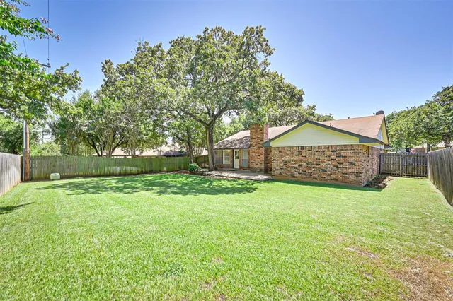 a house with green field in front of it