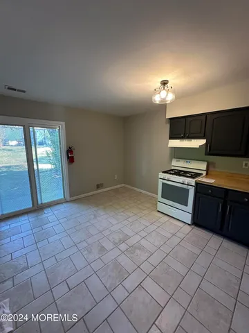 a view of a kitchen with microwave and cabinets