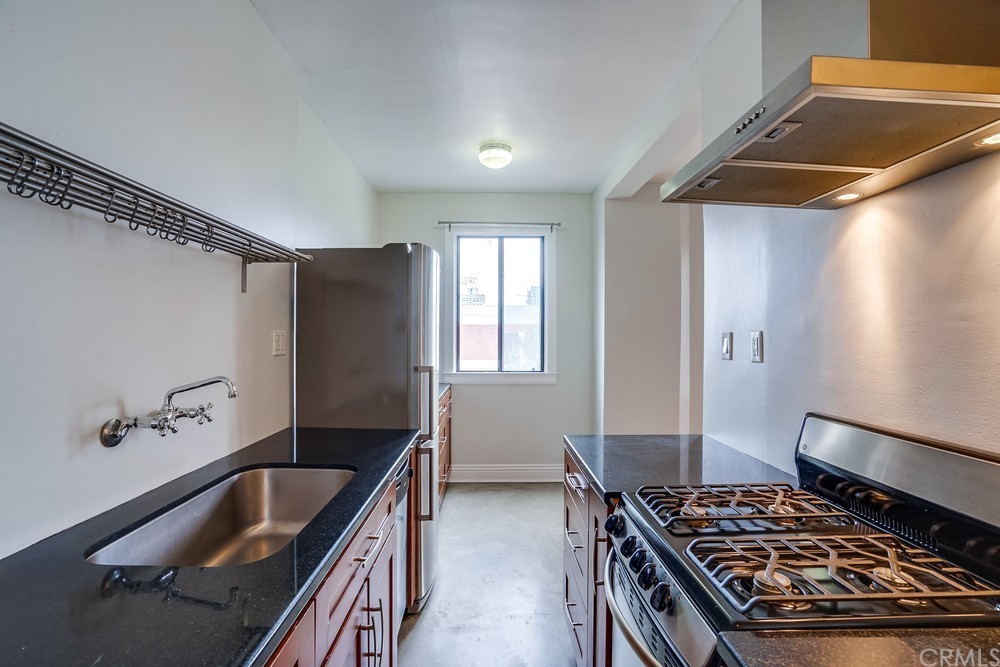 315 West 3rd Street, Unit 507 Long Beach, CA 90802 - Photo 13 of 25 a kitchen with sink refrigerator and stove