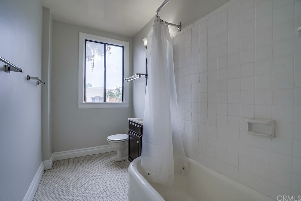 315 West 3rd Street, Unit 507 Long Beach, CA 90802 - Photo 16 of 25 a bathroom with a granite countertop sink a toilet and shower