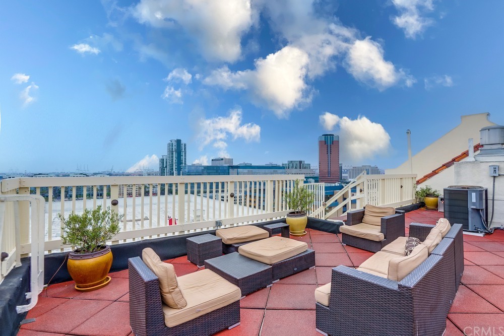 315 West 3rd Street, Unit 507 Long Beach, CA 90802 - Photo 21 of 25 a living room with furniture a lamp and a potted plant